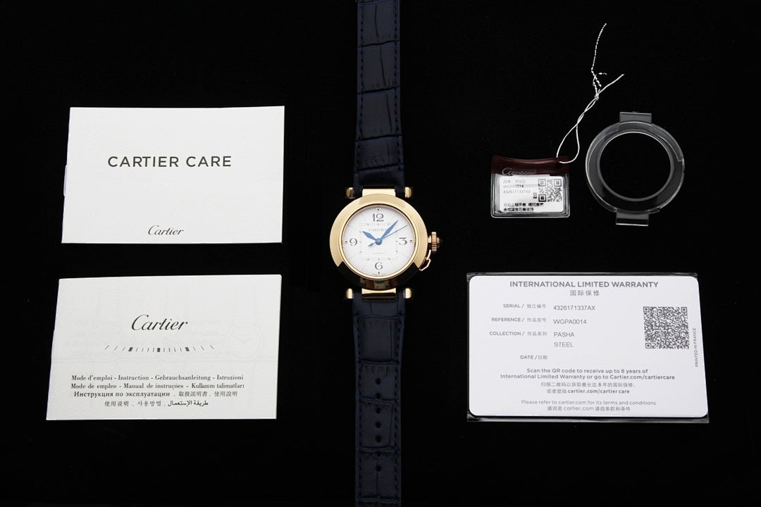 Cartier watch with blue leather strap alongside warranty papers and card set