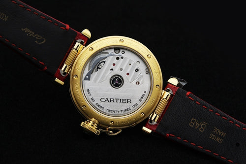 Cartier watch caseback with visible movement, red leather strap, gold-tone bezel