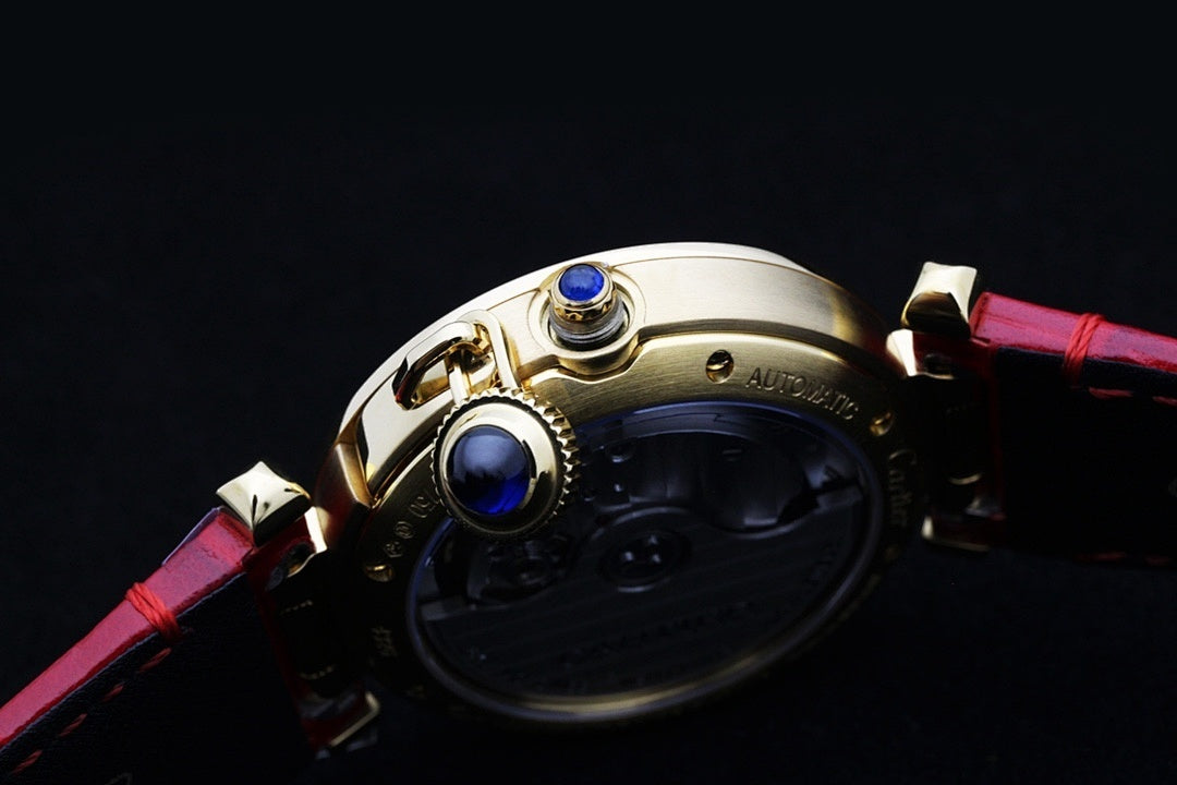 Cartier watch crown with blue jewel detail and red leather strap