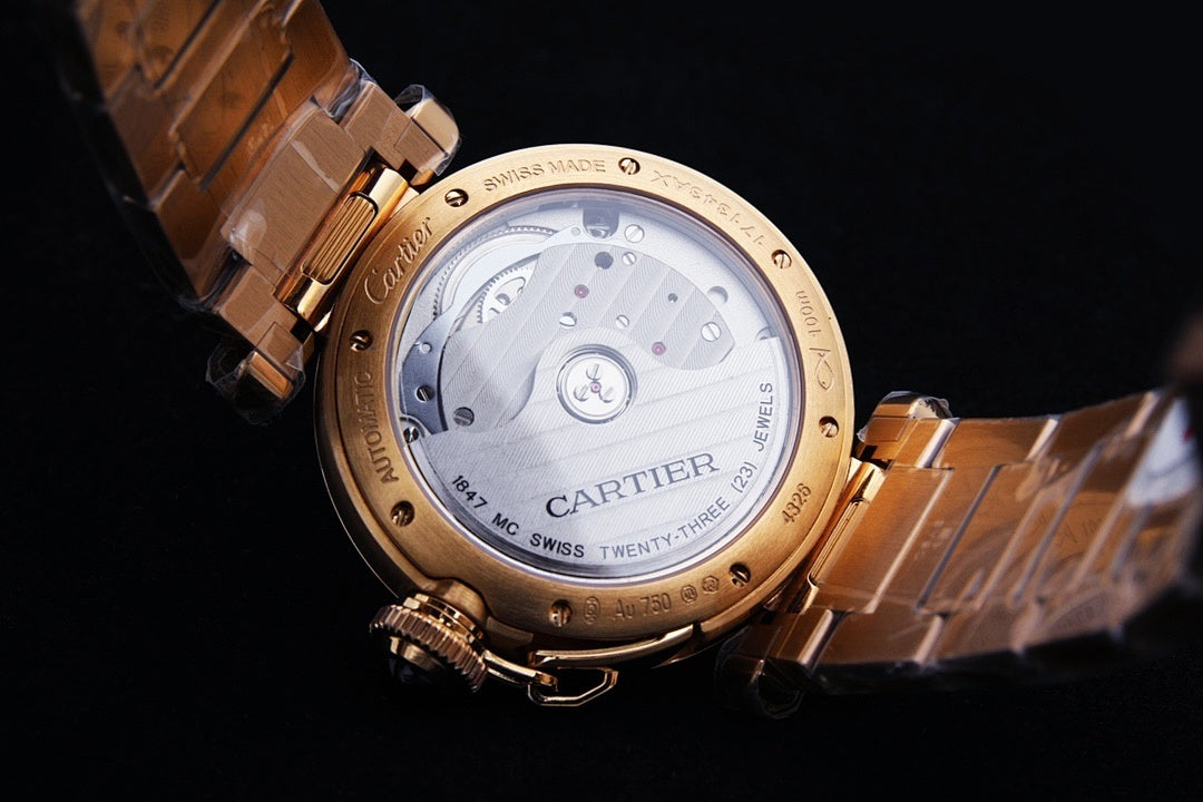 Gold wristwatch caseback with engraved markings and linked bracelet