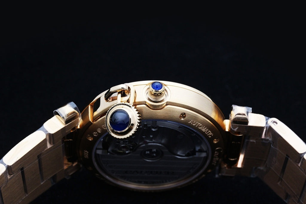 Gold wristwatch back with blue crown detail and metal link bracelet