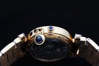 Gold wristwatch back with blue crown detail and metal link bracelet