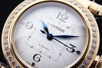 Gold wristwatch with white dial, blue hands, Roman numerals, and diamond bezel