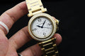 Gold-tone Cartier wristwatch with crystal-studded bezel, white dial, metal bracelet