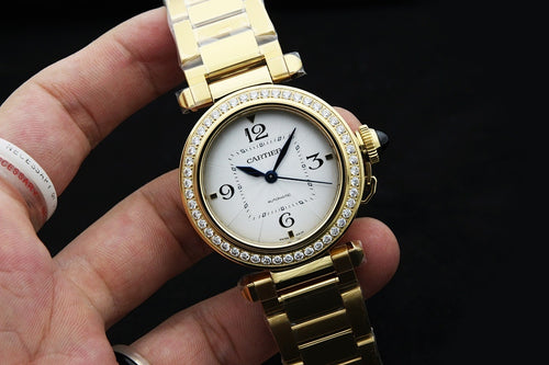 Gold-tone Cartier wristwatch with crystal-studded bezel, white dial, metal bracelet
