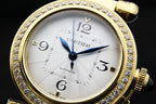 Gold-tone watch with white dial, diamond bezel, blue hour and minute hands