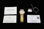 Cartier watch accessories set with warranty card, booklet, and watch on display