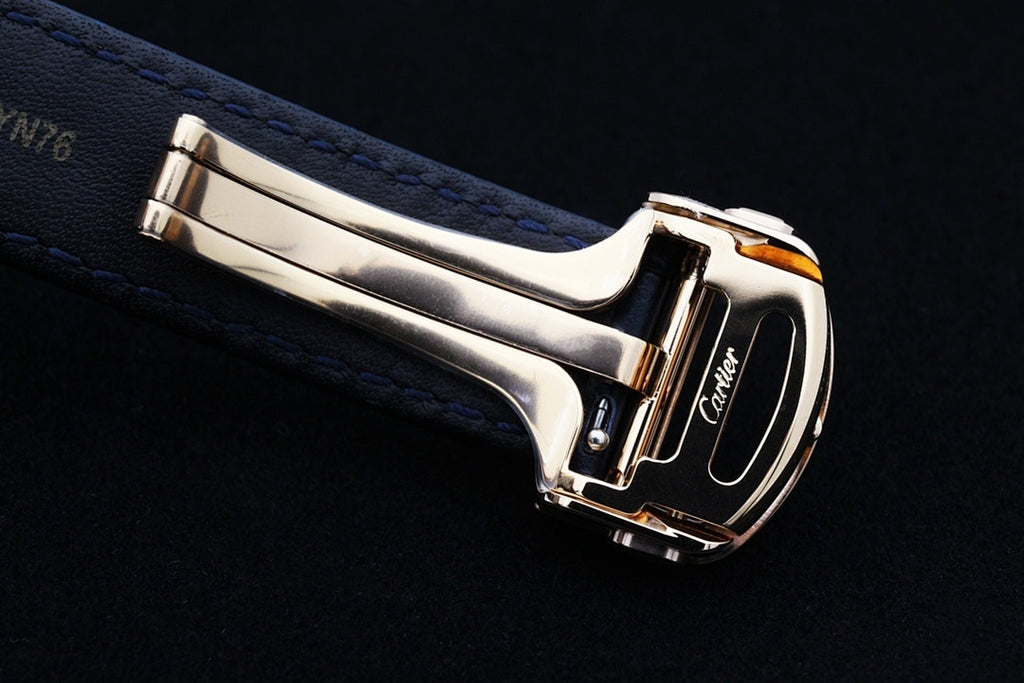 Cartier watch with blue leather strap and gold-tone metal buckle clasp, side view
