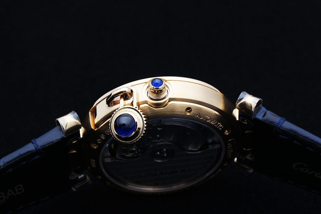 Cartier watch case detail with blue jewel accents and gold-tone hardware, blue strap