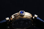 Cartier watch case close-up with blue jewel and screw accents, blue leather strap