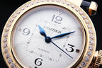 Cartier automatic watch with white dial, blue hands, diamond-studded gold bezel