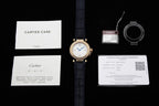 Cartier watch on blue leather strap with care and warranty papers and small accessory items