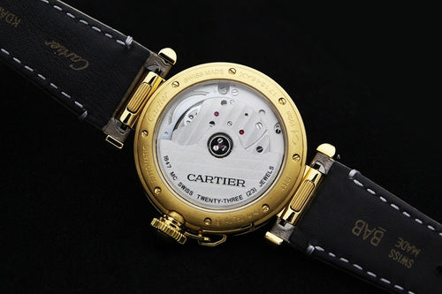 Cartier watch back view with gold case, see-through dial, and gray leather strap