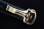 Cartier watch side view with gold case and gray leather strap