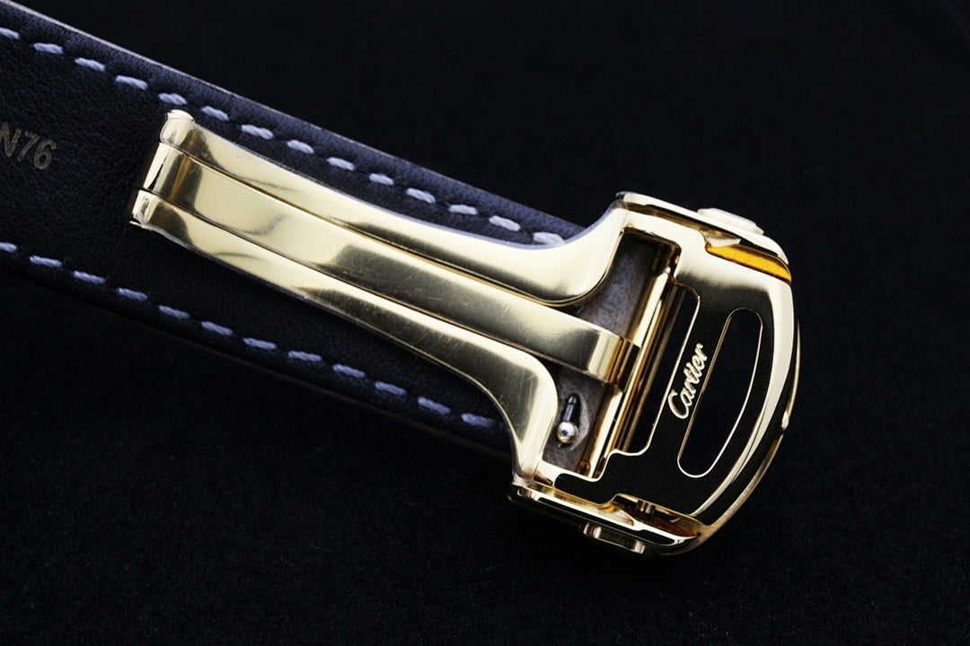 Cartier watch side view with gold case and gray leather strap