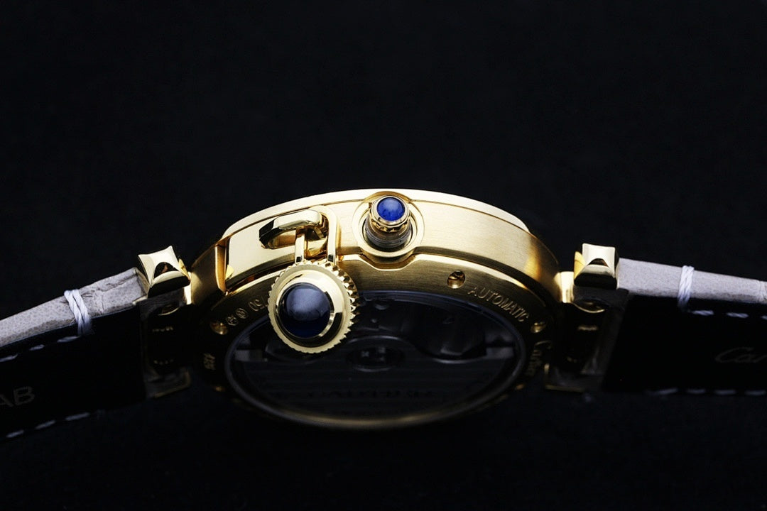 Cartier watch with gold case and blue crown accents on gray leather strap