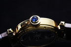 Cartier watch with gold case, blue crown accents, and gray leather strap