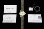 Cartier watch with gray leather strap, plus warranty and care documents