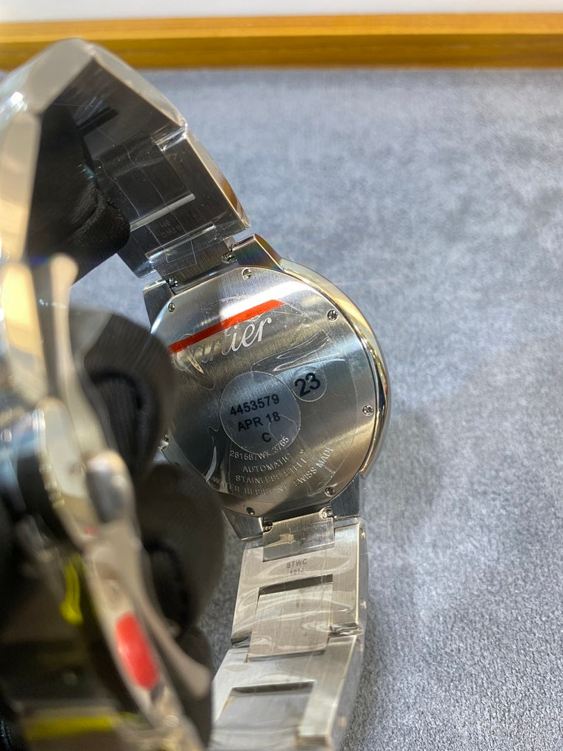 Silver watch caseback and metal bracelet with engraved markings near the side