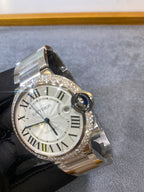 Silver diamond-bezel wristwatch with white Roman dial and side crown on metal bracelet