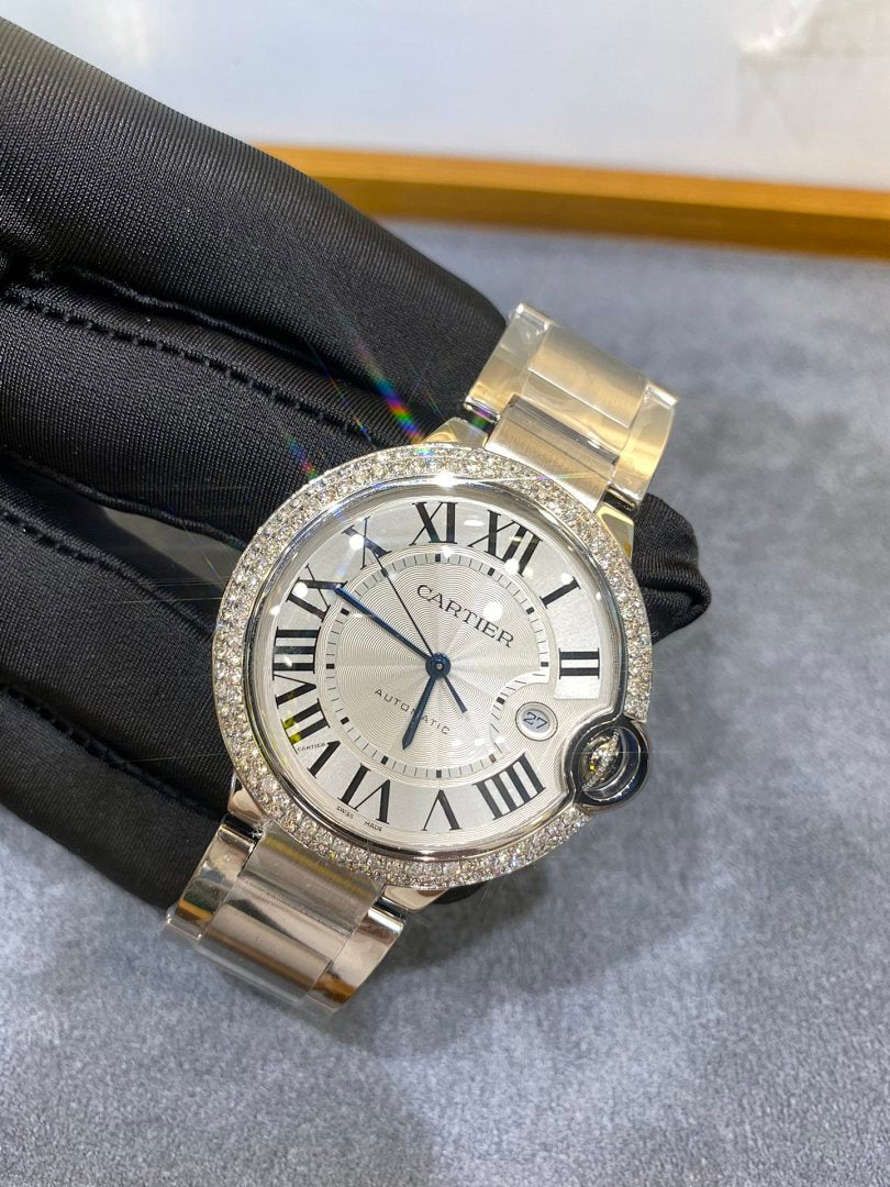 Silver wristwatch with diamond bezel, Roman numeral dial and metal bracelet with round crown