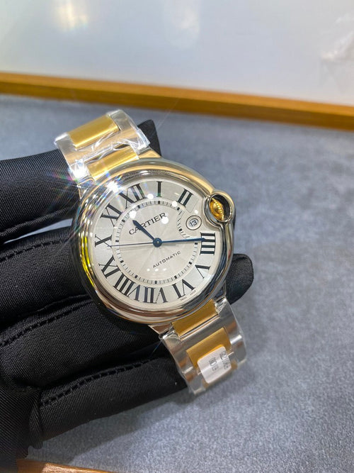 Cartier watch front view on black glove, white dial with Roman numerals and gold bezel