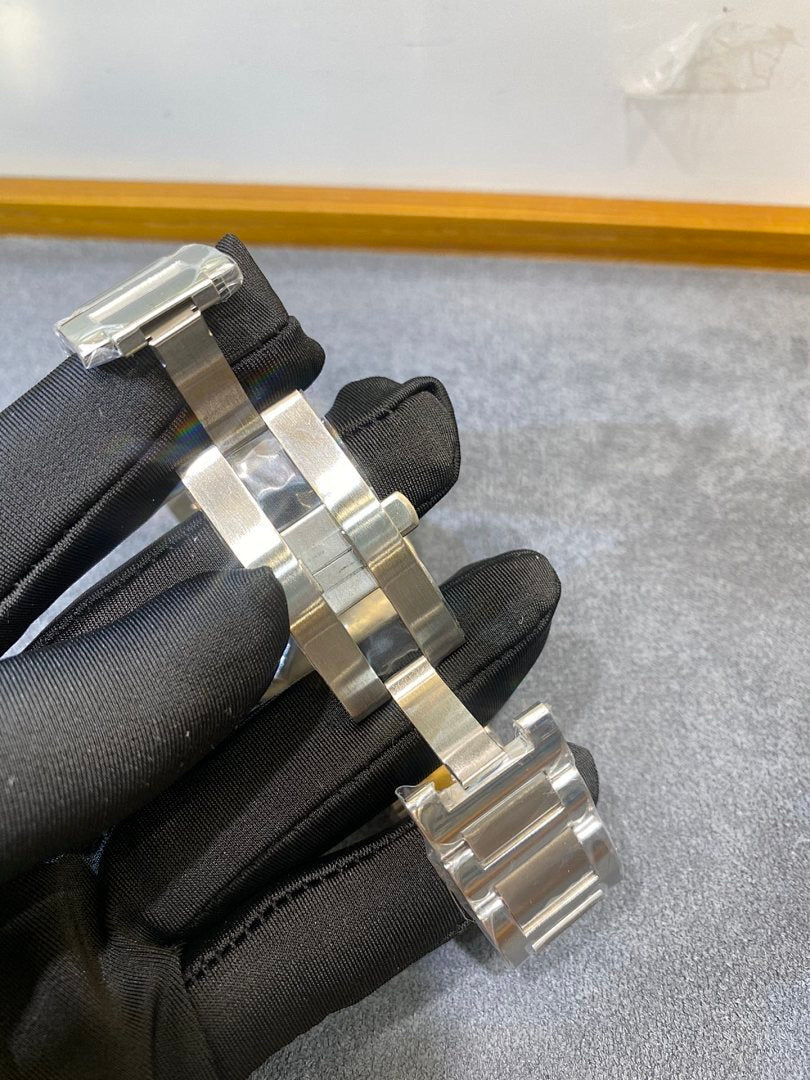 Cartier watch link bracelet on black glove, silver and gold two-tone metal band