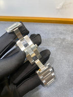 Cartier watch link bracelet on black glove, silver and gold two-tone metal band
