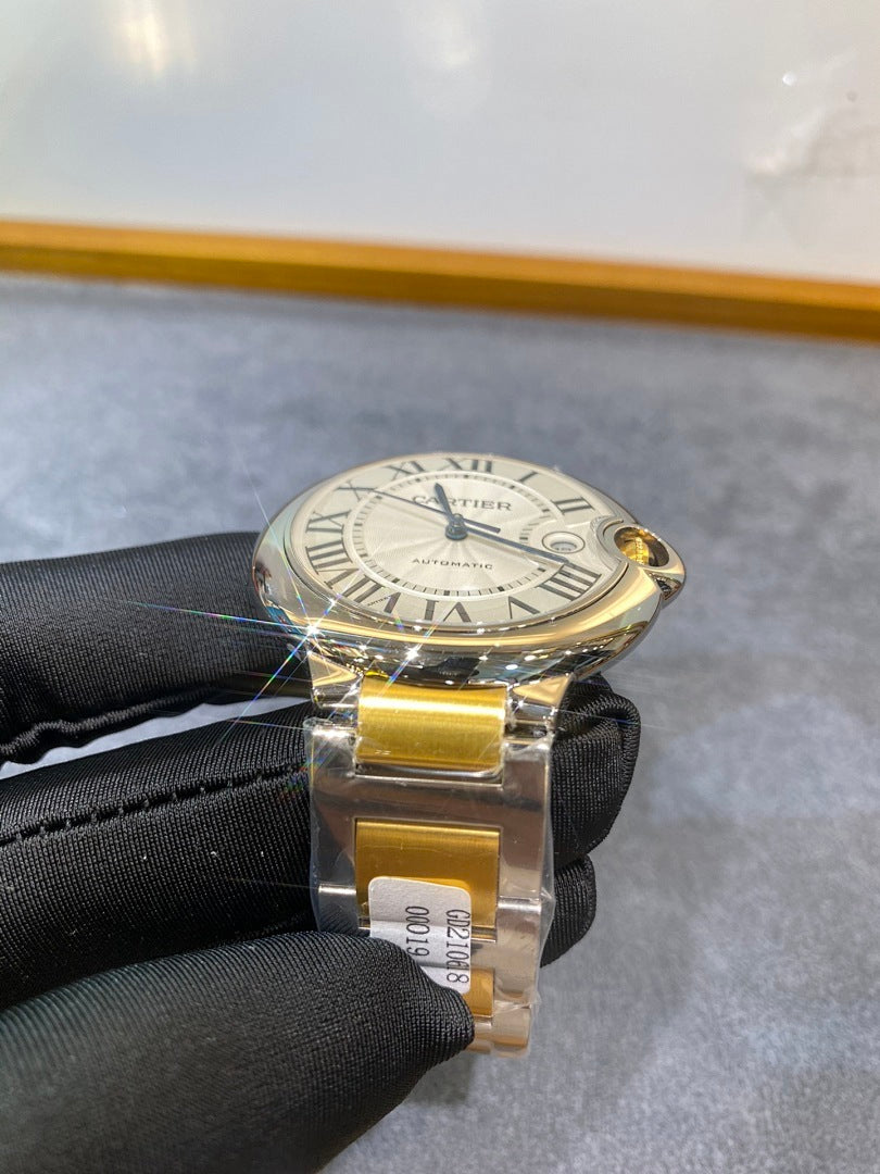 Cartier watch on black glove, white dial with Roman numerals, gold and silver bracelet