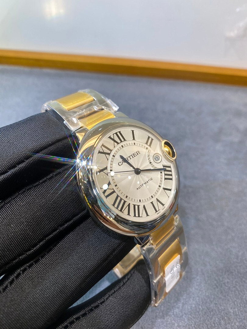 Cartier watch with white dial and blue hands, gold-accented bezel, on black glove