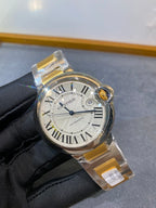 Cartier watch front with Roman numerals and crown detail, gold and silver two-tone
