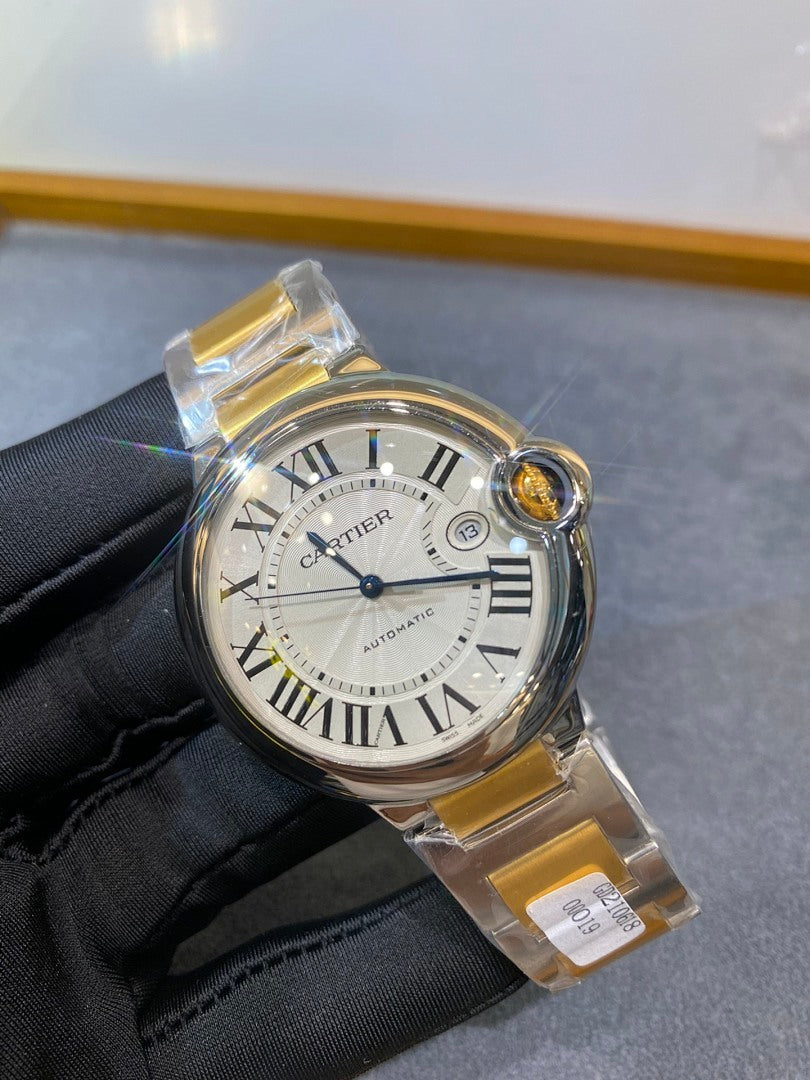 Cartier watch front with Roman numerals and crown detail, gold and silver two-tone