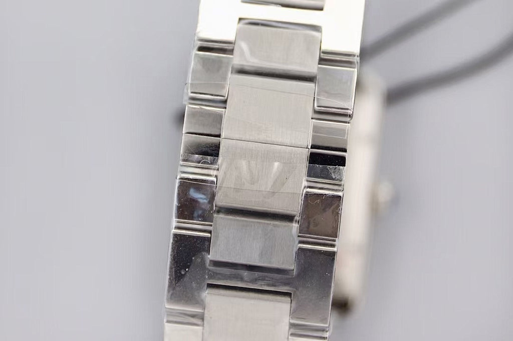 Cartier wristwatch bracelet close-up, polished and brushed silver links