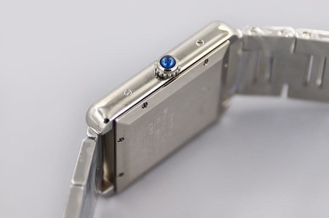 Cartier wristwatch side profile, blue gemstone crown on silver case