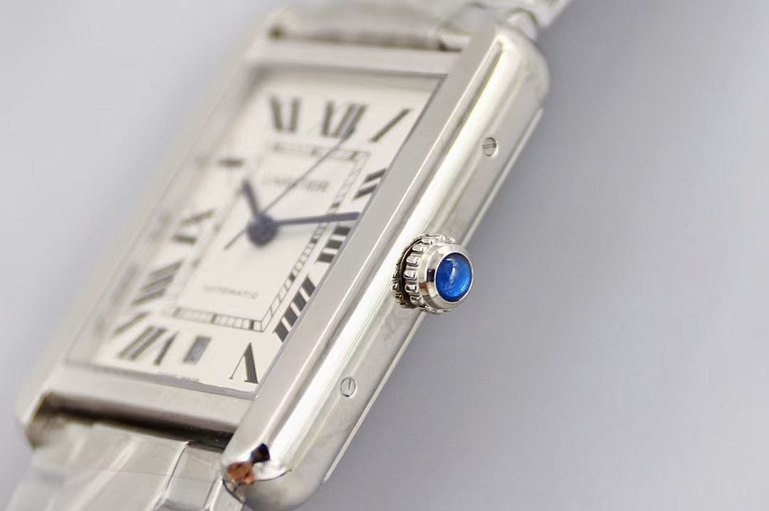 Cartier wristwatch dial close-up, Roman numerals and blue hands on silver face