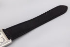 Black leather watch strap, angled view of rectangular silver case corner