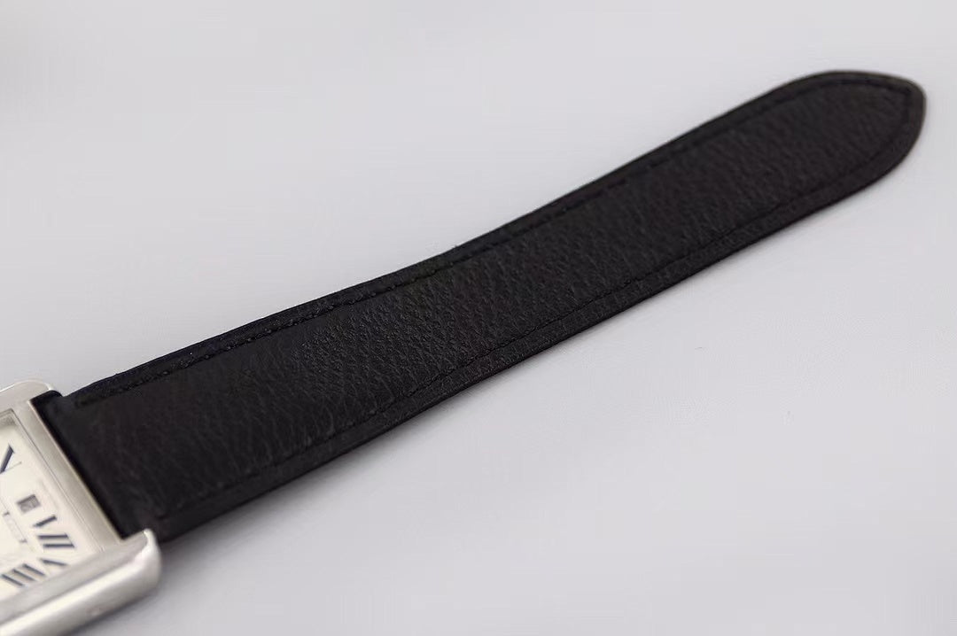 Black leather watch strap, angled view of rectangular silver case corner