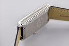 Rectangular stainless watch case side with crown and black leather strap