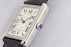 Rectangular silver watch with white dial, Roman numerals, black leather strap
