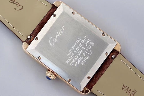 Cartier wristwatch case back with engraved metal plate and dark brown leather strap