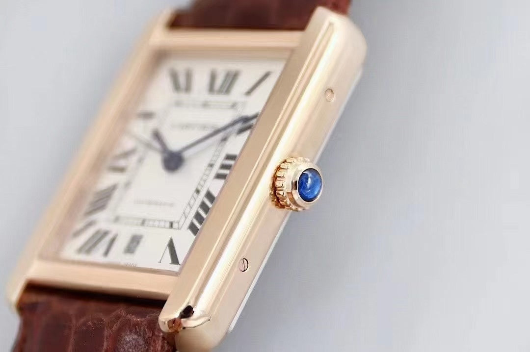 Cartier rectangular wristwatch with white dial, Roman numerals, and brown leather strap