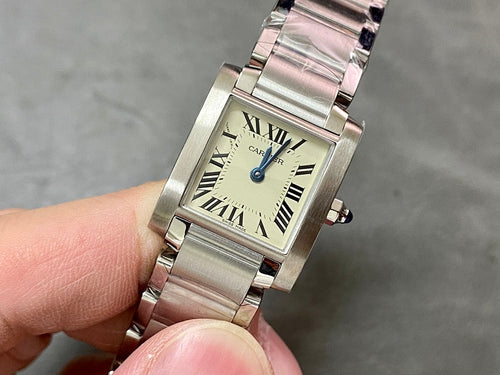 Cartier rectangular wristwatch with silver stainless bracelet, Roman numeral dial, blue crown.
