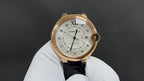 Cartier automatic watch with gold-tone case, white dial, black leather strap, Roman numerals