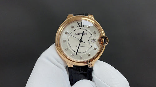 Cartier automatic watch with gold-tone case, white dial, black leather strap, Roman numerals