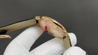 Cartier watch with gold-tone case, black leather strap, side profile and caseback view