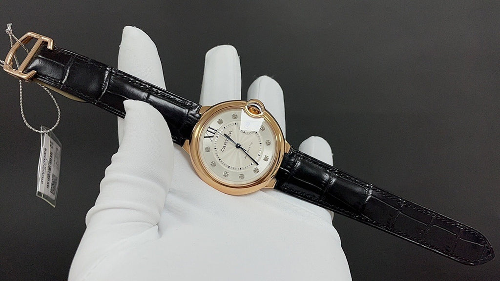Cartier automatic watch with black leather strap and gold-tone case, front dial and crown
