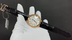 Cartier automatic watch with black leather strap and gold-tone case, front dial and crown