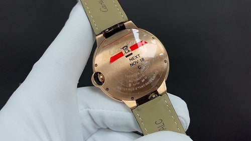 Cartier watch side view, gold-tone case and leather strap on display