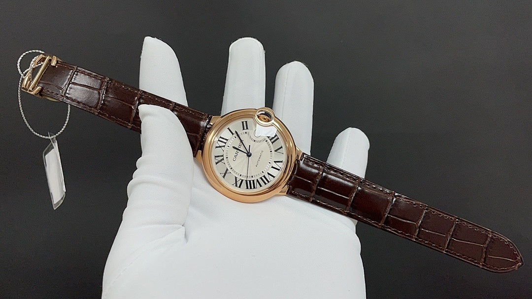 Cartier watch on brown leather strap with Roman numeral dial, circular gold case