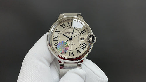 Cartier round steel watch with white dial, Roman numerals, blue hand and crown.